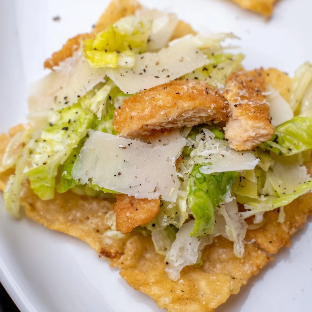 Crispy Chicken Caesar Salad Chips arranged on a platter with lemon wedges, delivering a savory, tangy snack perfect for game day gatherings.