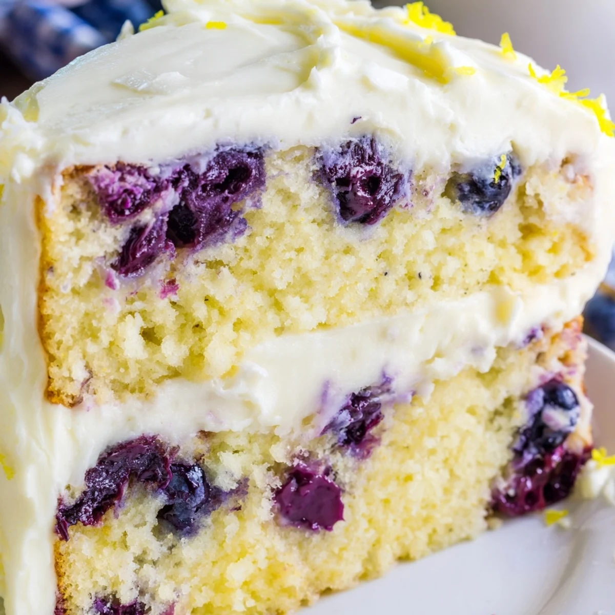 Moist Lemon Blueberry Cake with Cream Cheese Frosting on a plate, ready for a springtime gathering.