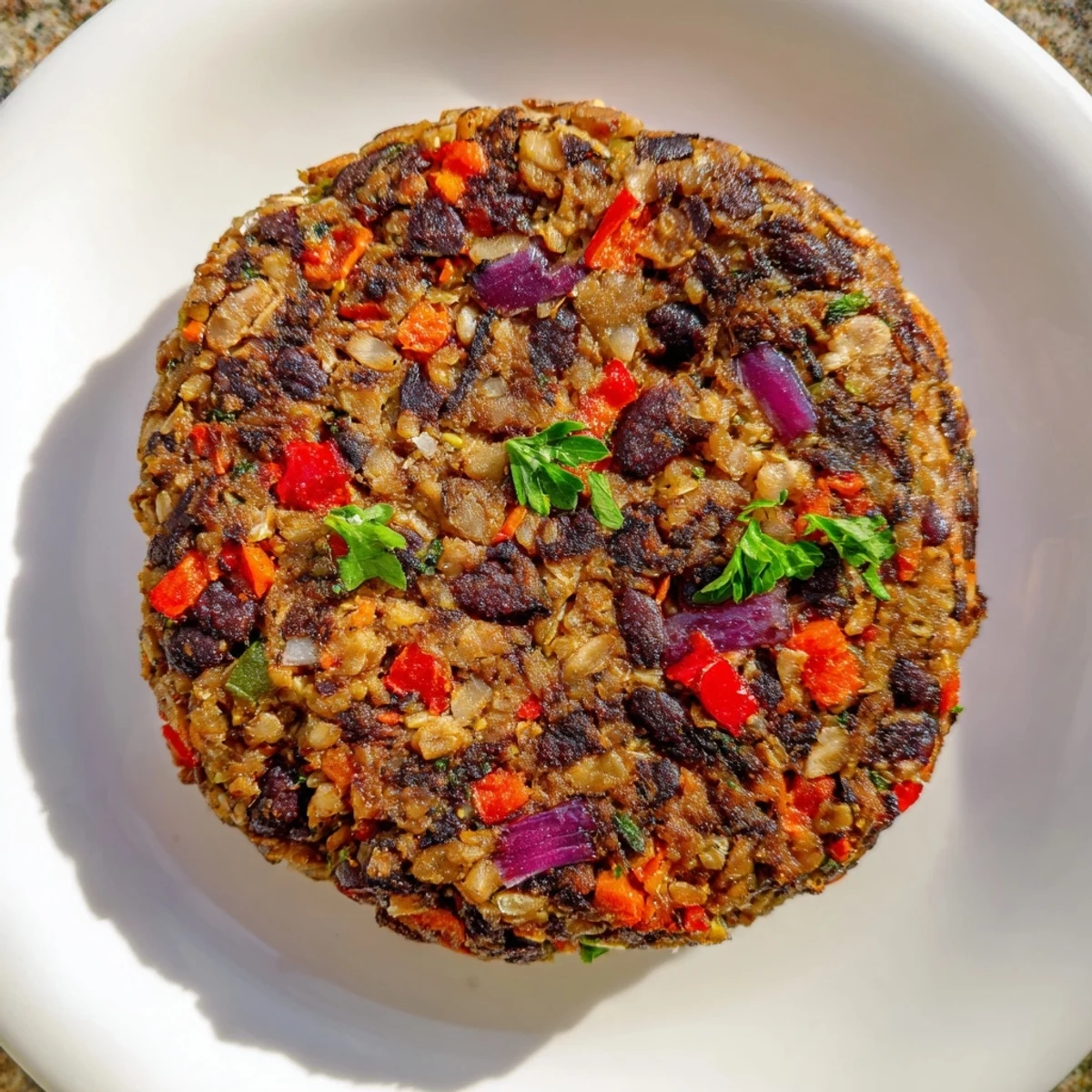 Mushroom veggie burgers are sizzling in a skillet, releasing smoky aromas with black beans and spices, ready to serve.