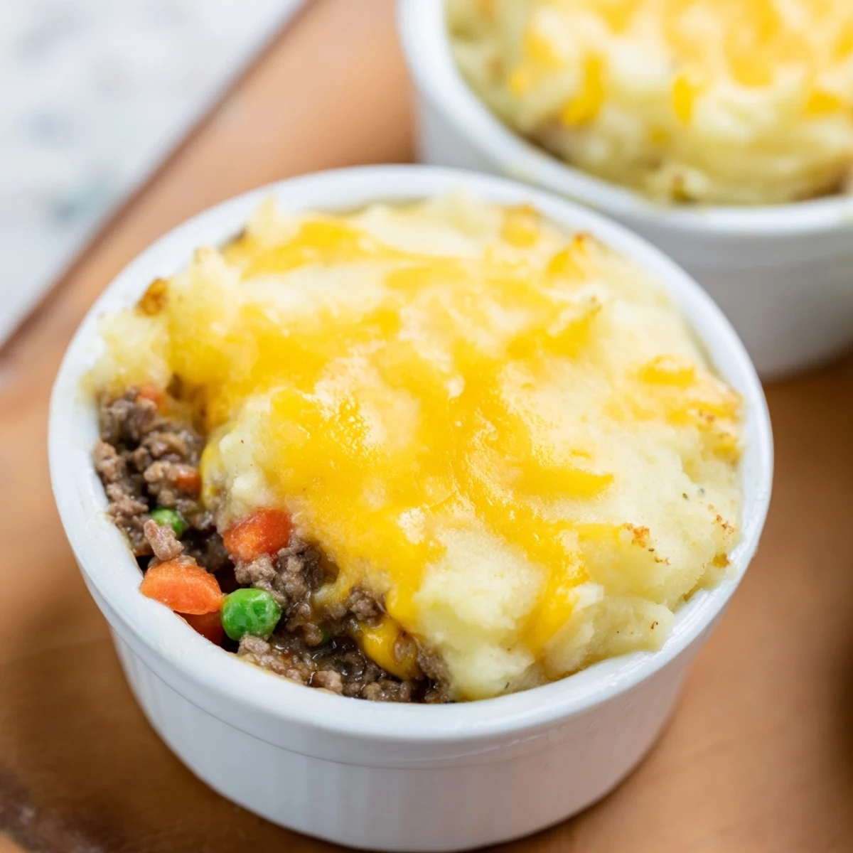 Close-up of Mini Shepherds Pie showing fluffy potato peaks and a rich beef and vegetable filling.