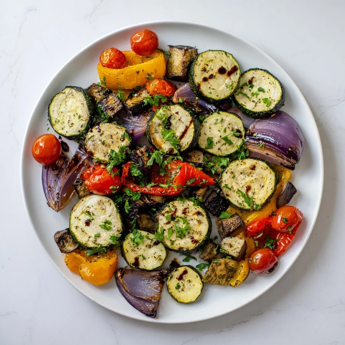 Freshly roasted Italian Roasted Vegetables tossed with herbs, paired with a side of crusty bread for a wholesome, vegan dinner.