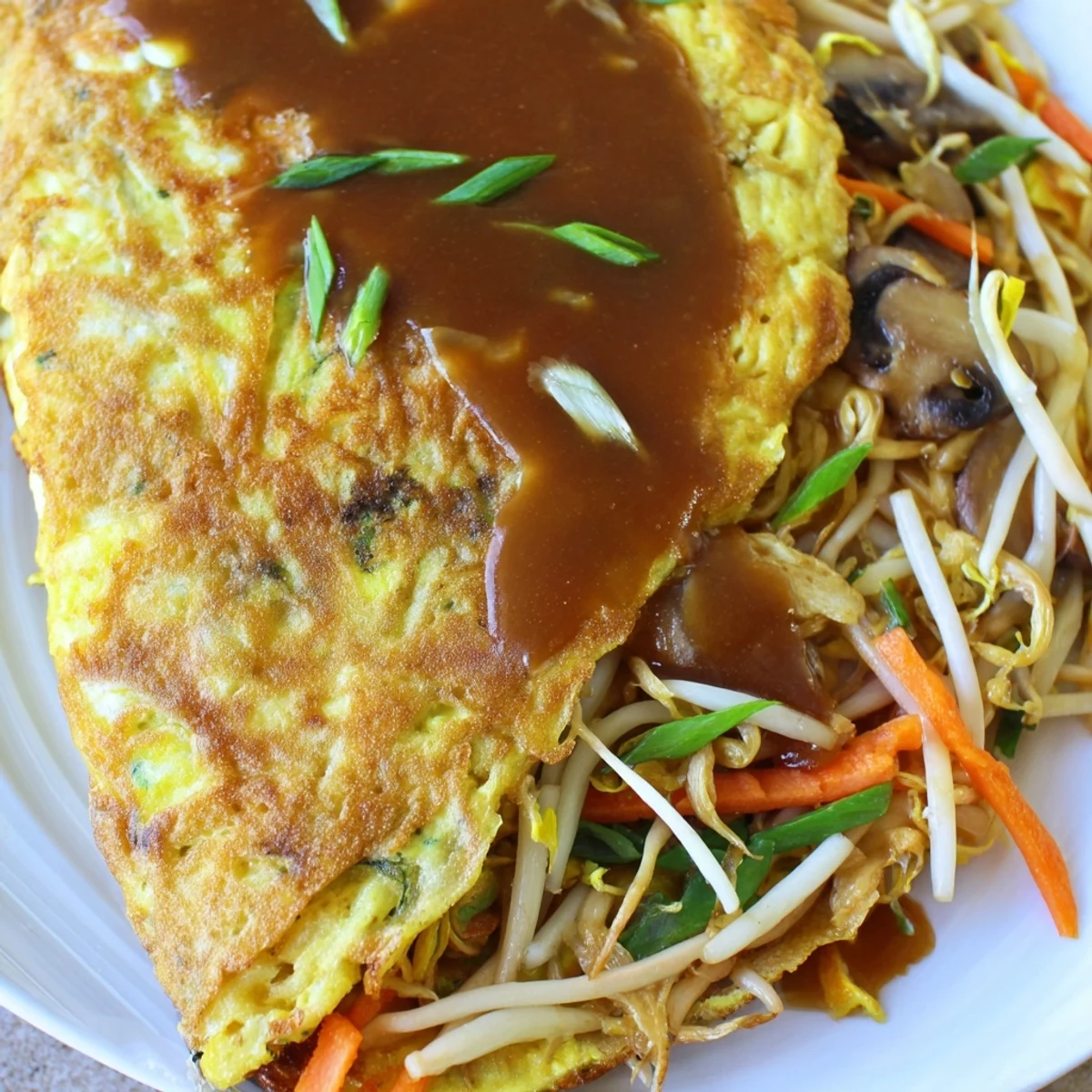 Golden brown crispy Egg Foo Young patties drizzled with rich savory brown gravy