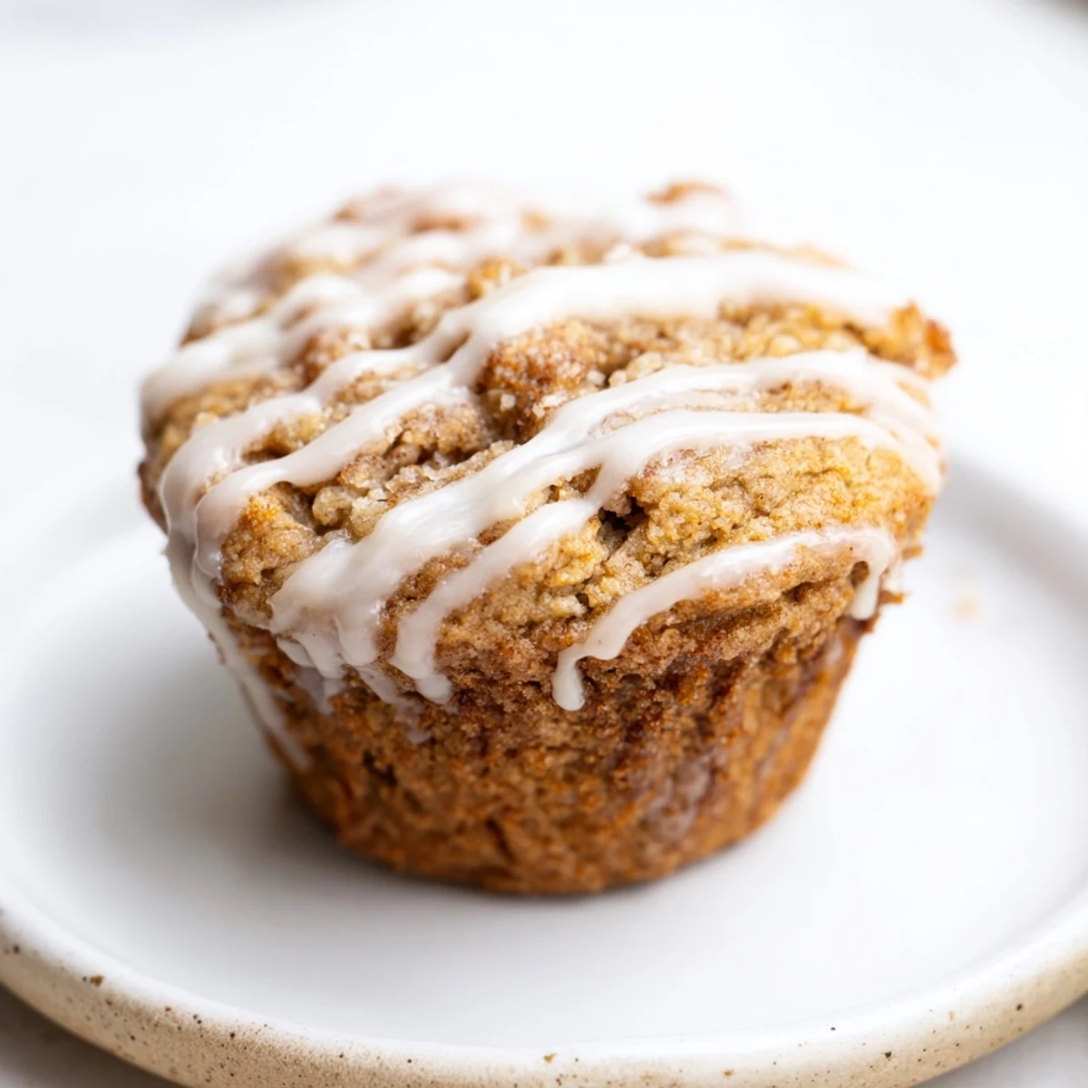 Freshly baked cinnamon roll protein muffins with golden tops and sweet cinnamon swirl centers