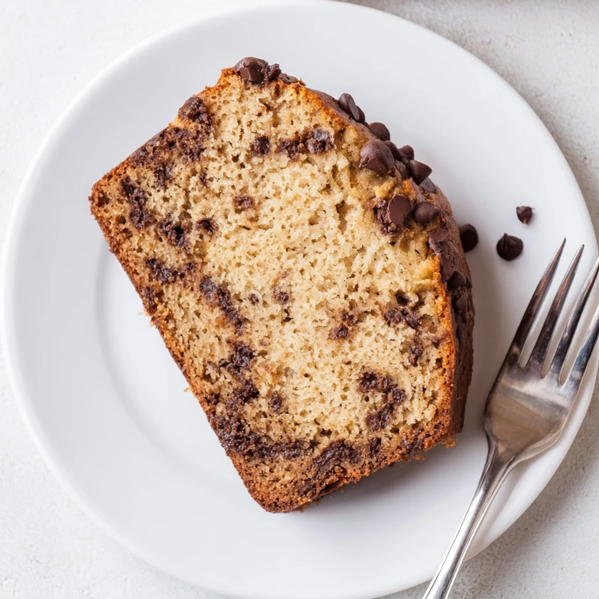 Warm classic chocolate chip banana bread fresh from oven with golden brown crust
