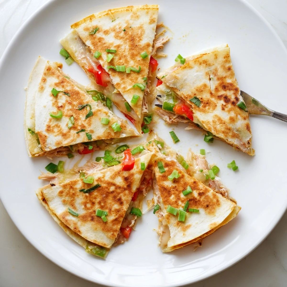 Golden baked chicken and cheese quesadillas with melted Mexican blend cheese and red bell pepper