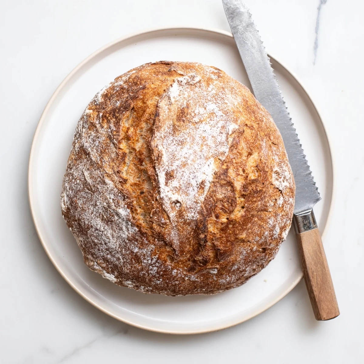 Sliced artisan no knead bread displaying soft crumb texture with golden crispy exterior