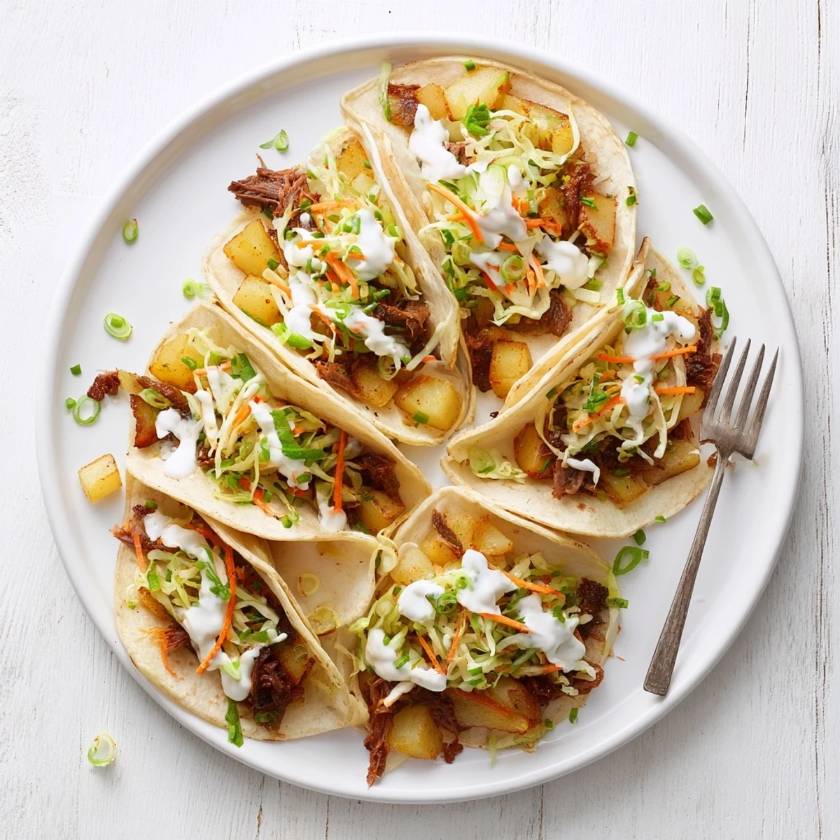 Irish tacos stacked high with crispy potato pieces and shredded corned beef topped with creamy dressing