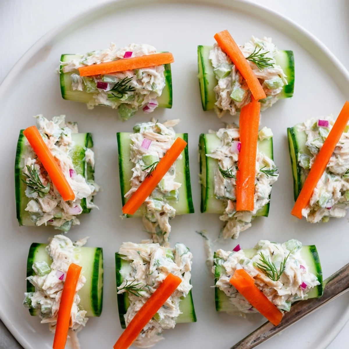 Crisp cucumber slices filled with savory chicken mixture for easy low-carb appetizer
