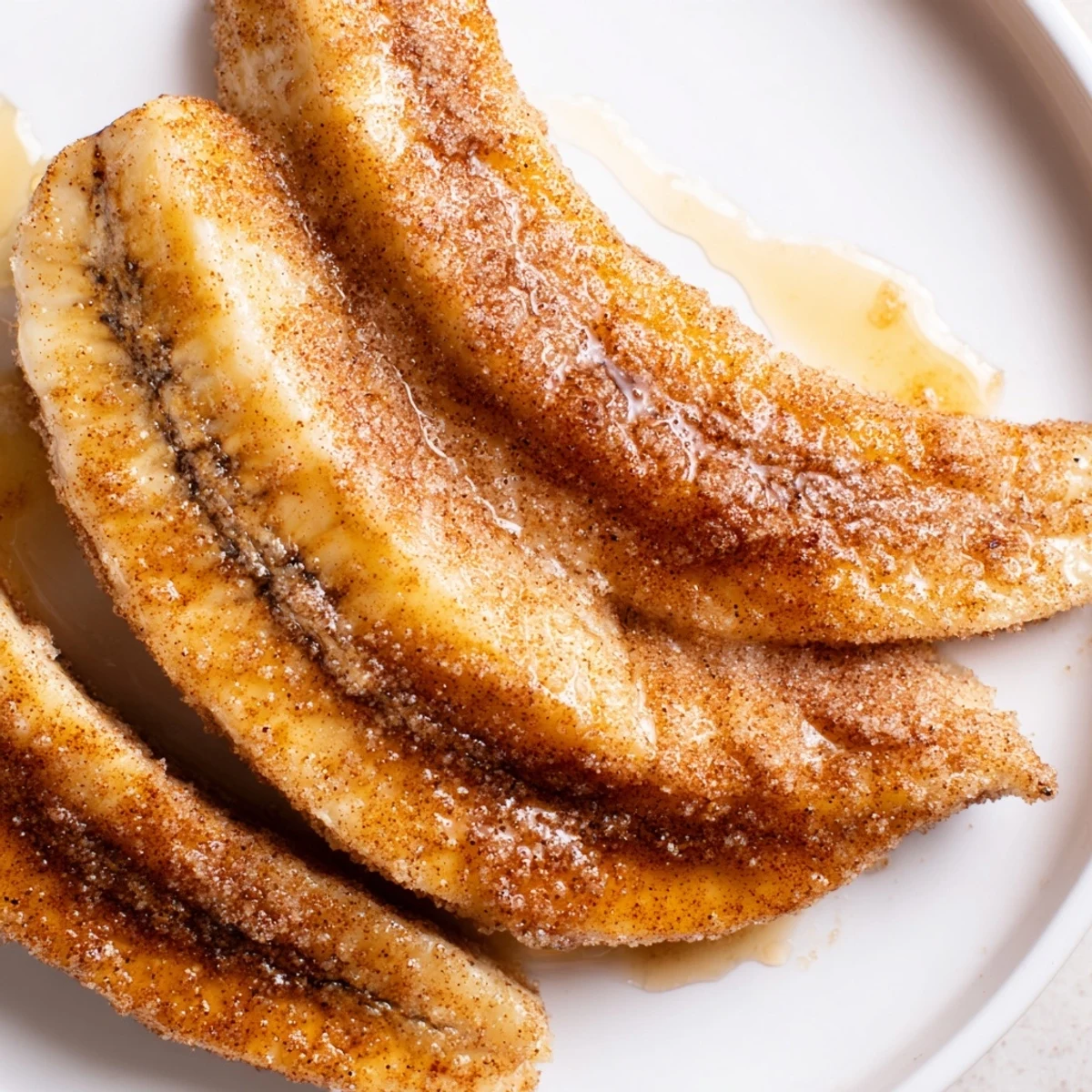 Golden pan fried cinnamon bananas caramelized in butter with warm brown sugar coating