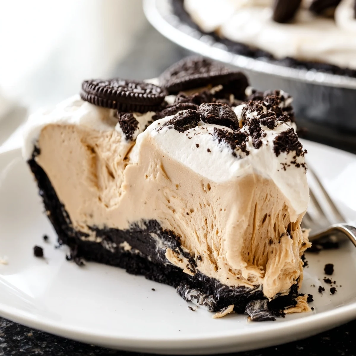 Creamy peanut butter Oreo pie with fluffy whipped topping and chocolate cookie crumbles