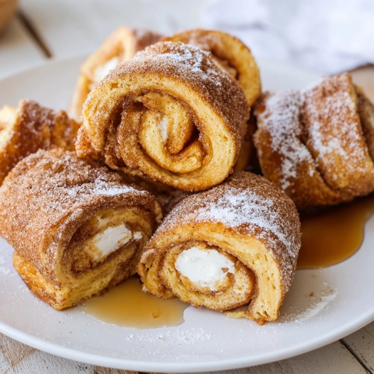 Warm Cinnamon Roll French Toast Roll Ups filled with sweet cream cheese