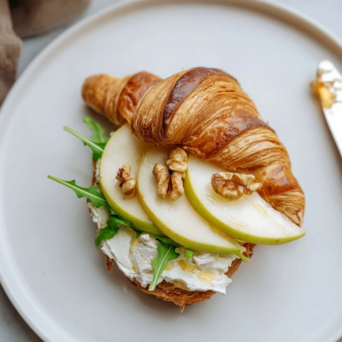 Apple Goat Cheese Croissant Sandwich arranged for brunch, buttery layers and tart apple
