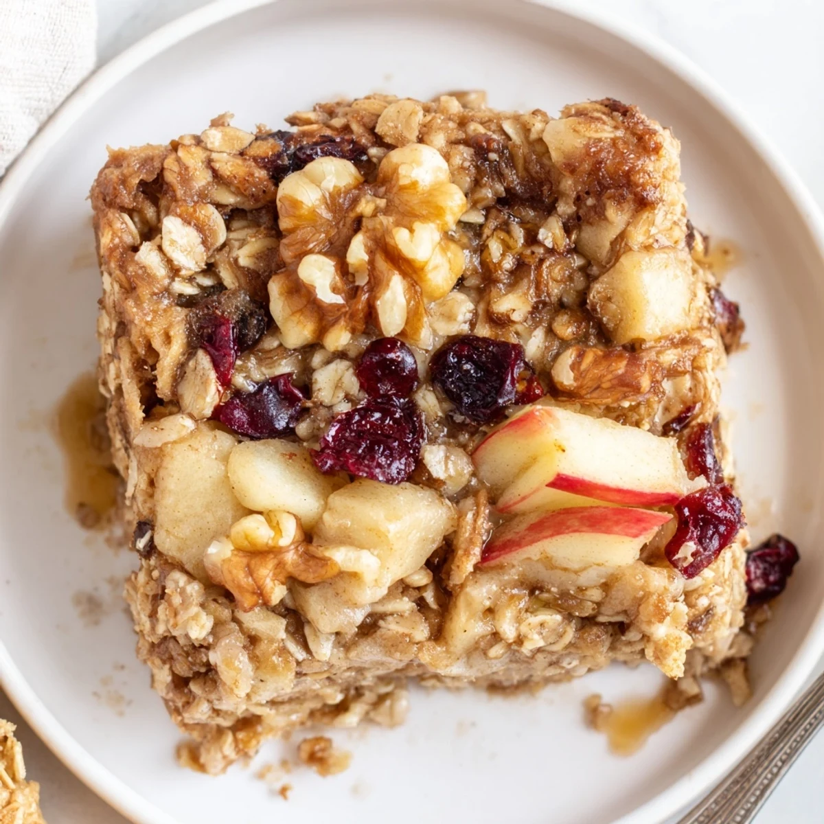 Warm square of Delicious Apple Cinnamon Oatmeal Bake Recipe For Mornings, steaming