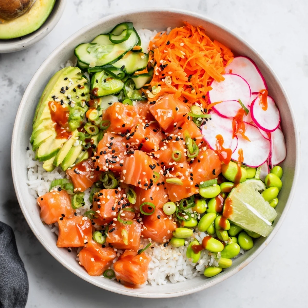 Vibrant salmon and avocado poke bowl topped with colorful vegetables and sesame seeds