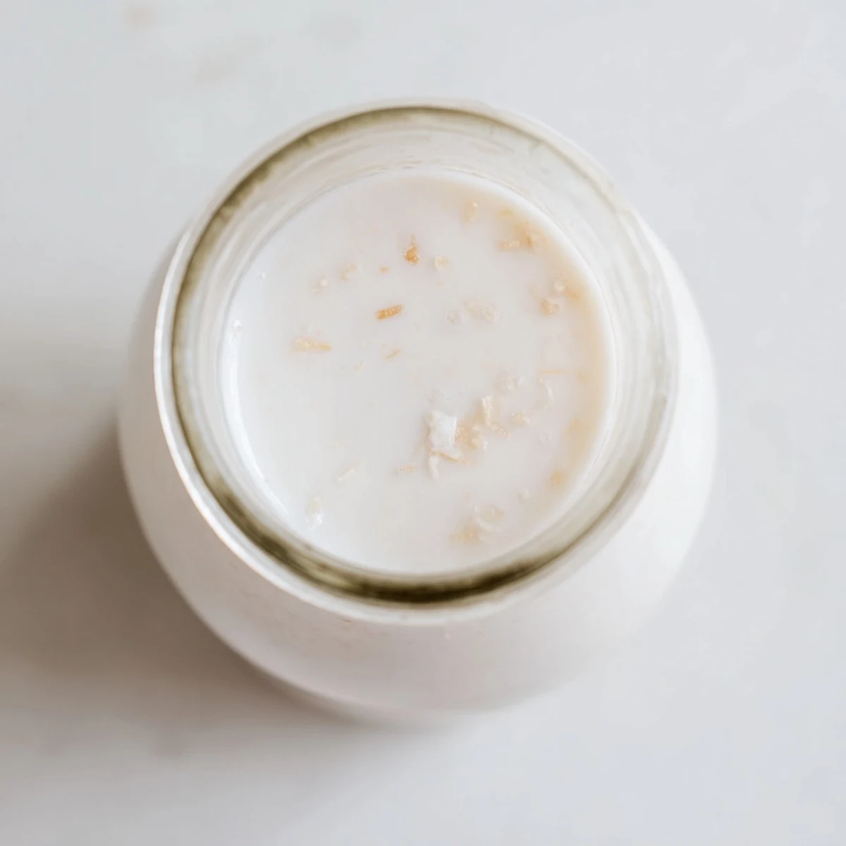 Fresh coconut milk recipe blended in a glass pitcher, perfect for tropical beverages and curries