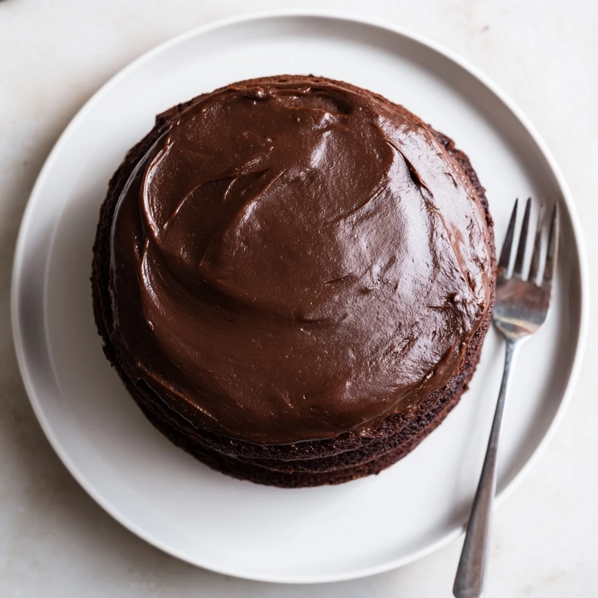 Slice of Matildas Chocolate Cake with velvety chocolate frosting and crumb texture visible