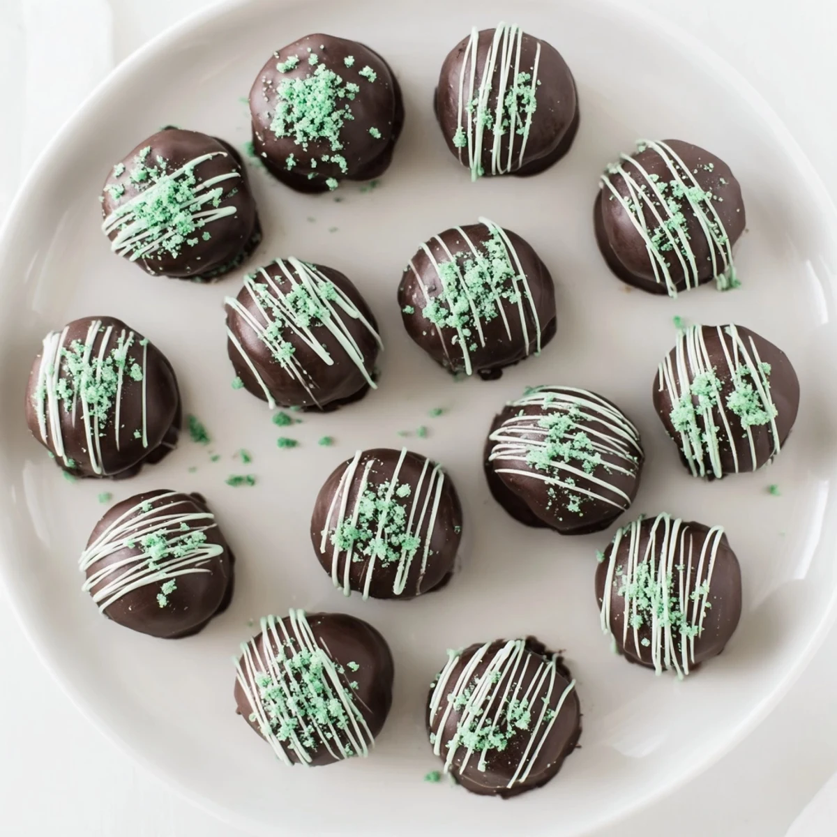 Bite-sized mint Oreo truffles coated in smooth dark chocolate with crushed cookie garnish