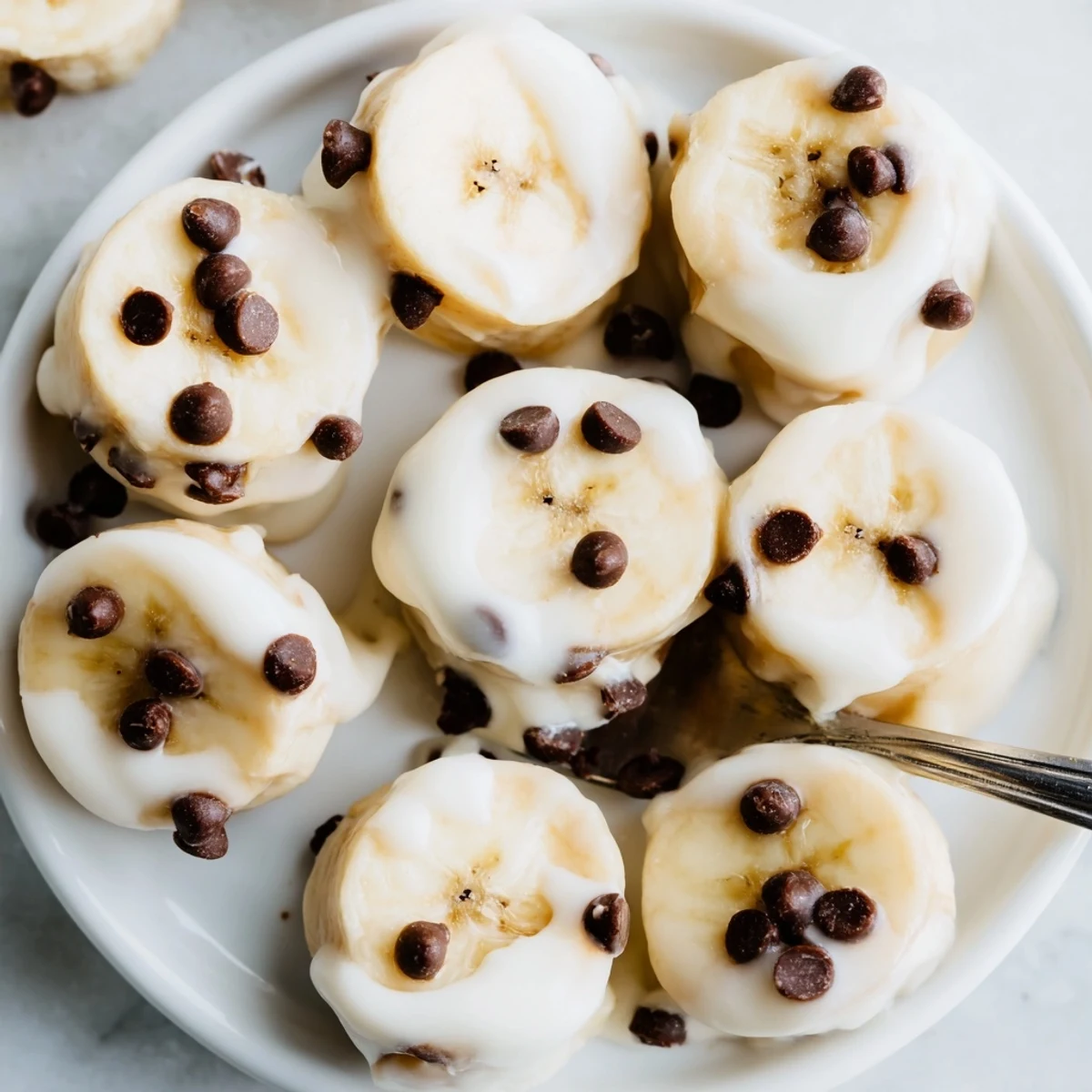 A stack of Frozen Banana Yogurt Bites, sweet banana flavor with crunchy nuts