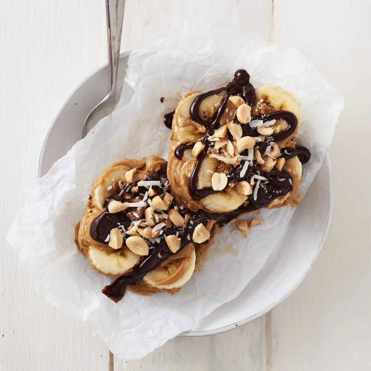 Chilled Chocolate Peanut Butter Banana bites on parchment, ready for quick snacking.