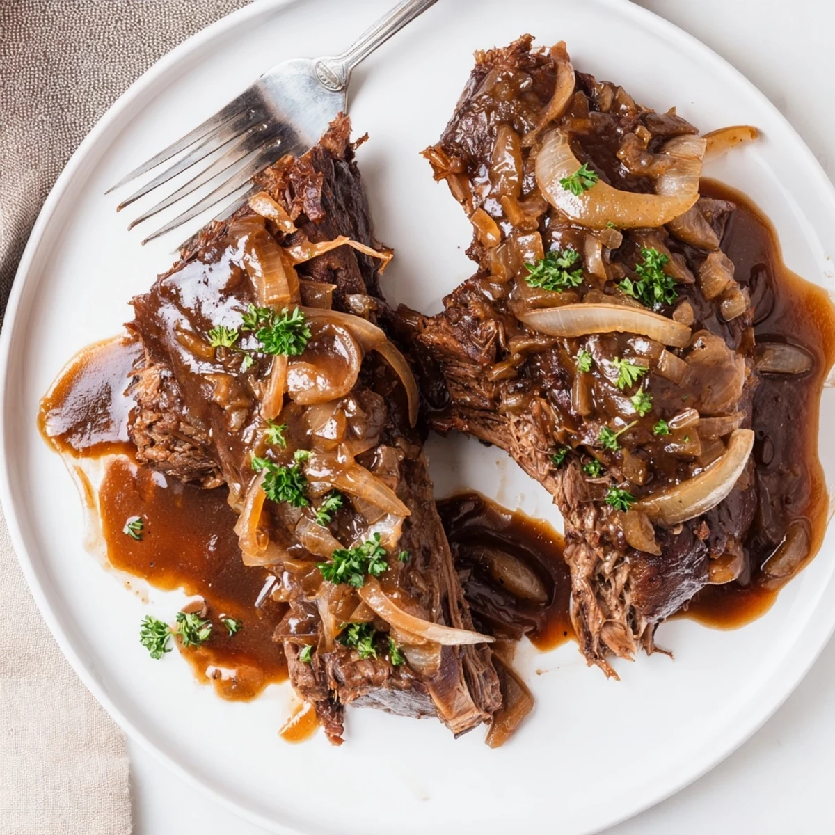 Juicy slow cooker balsamic chicken draped in a glossy, caramelized onion sauce