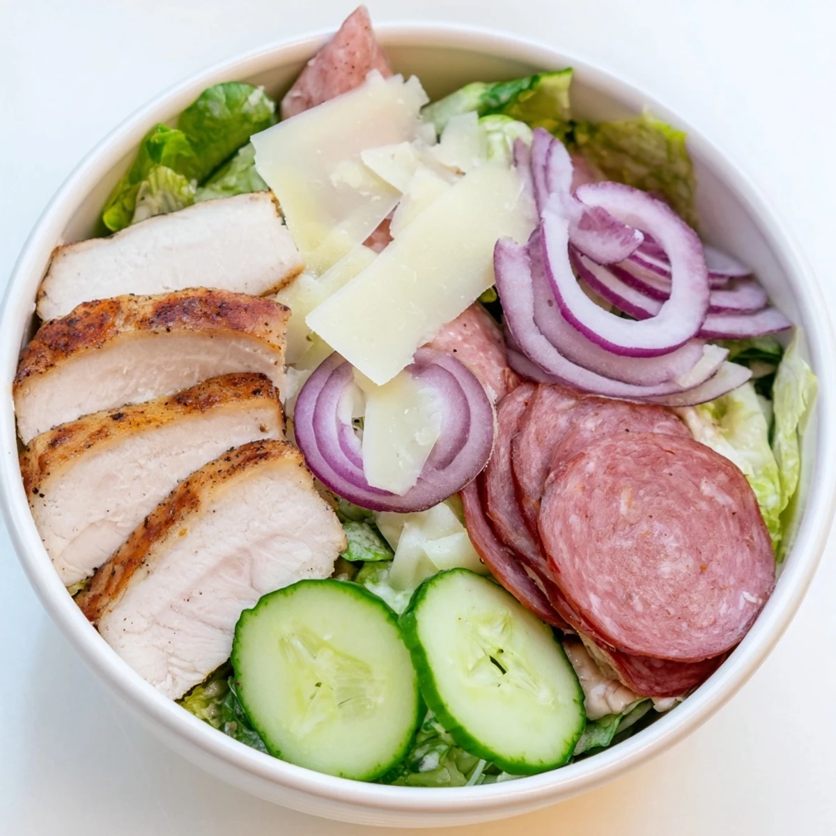 Flavor-packed Italian Grinder Chicken Salad featuring sliced grilled chicken, cured meats, and zesty red wine dressing.