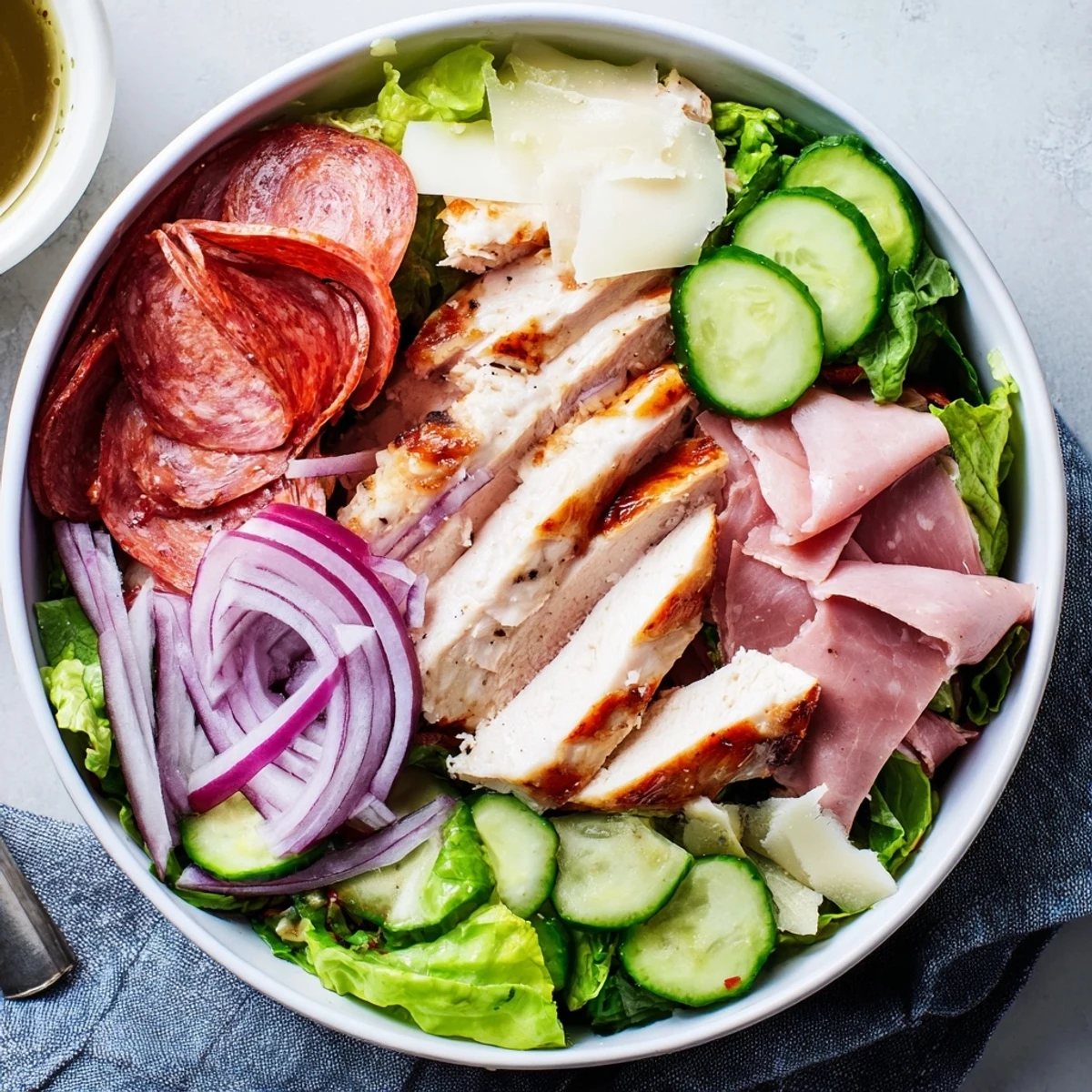 Mediterranean-style Italian Grinder Chicken Salad layered with tender chicken, romaine, tomatoes, and savory shaved provolone cheese.