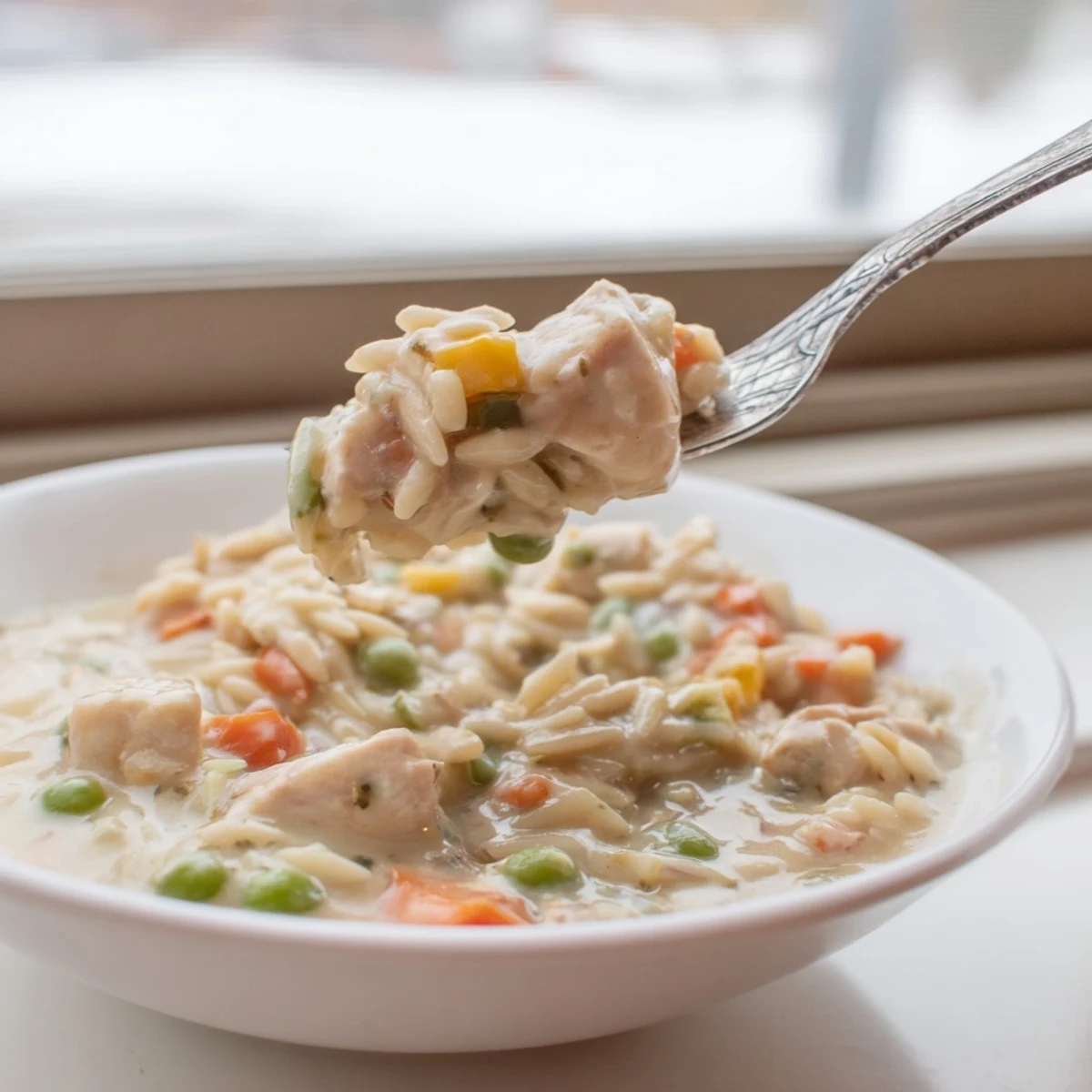 Golden chicken and vegetables simmer in a rich parmesan sauce with tender orzo pasta.