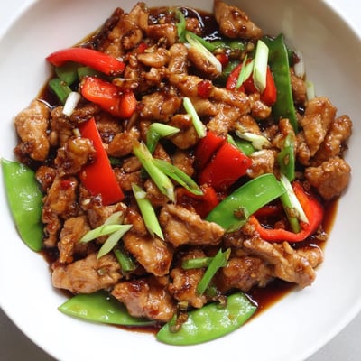 Tender stir fried Chinese garlic chicken glistening in a rich garlic soy sauce